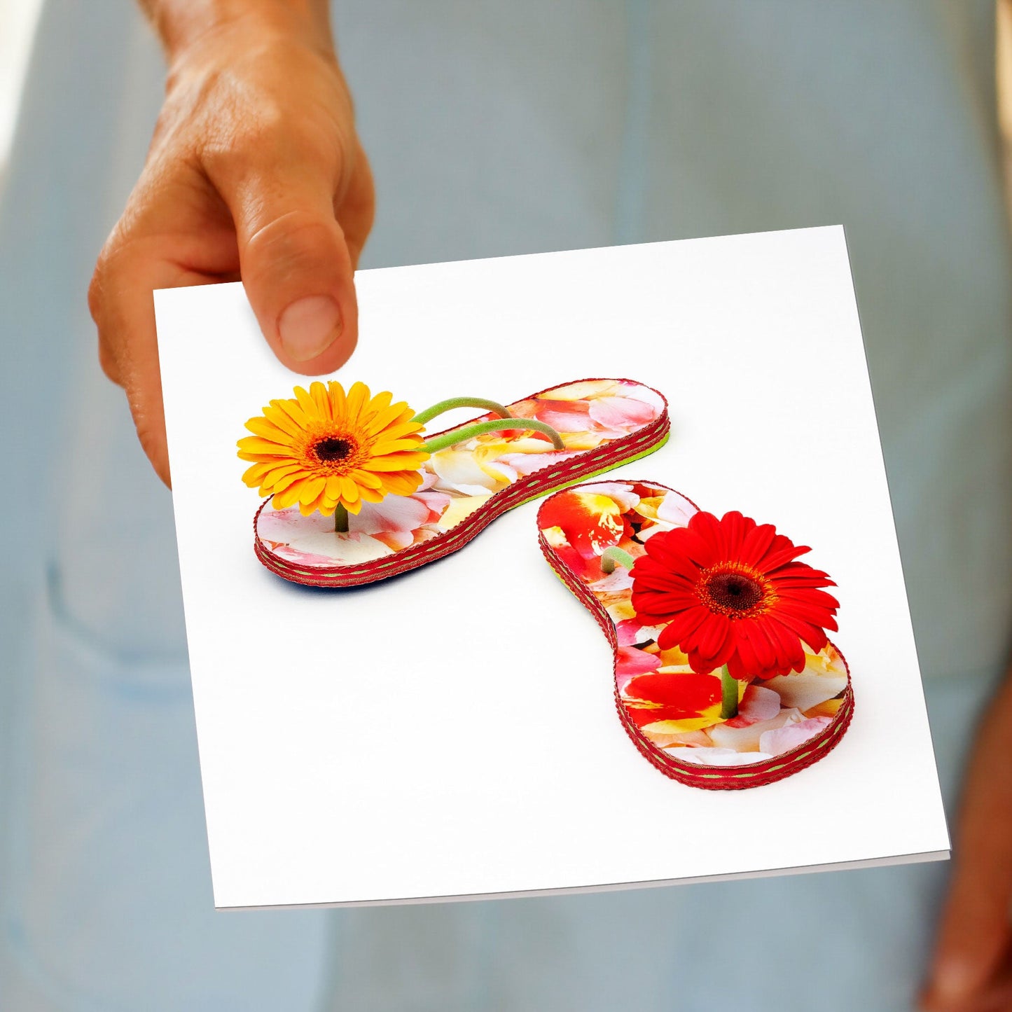 A colourful gerbera jandals greeting card from Golly Gosh Creations. A quality square card created from bright gerbera daisies.