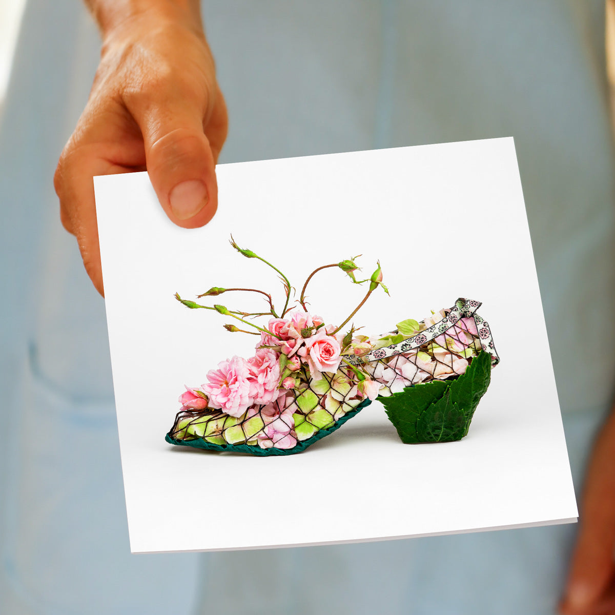 A hand held pretty greeting card from Golly Gosh Creations. This cecile brunner mesh shoe design is delicately crafted from fresh flowers.