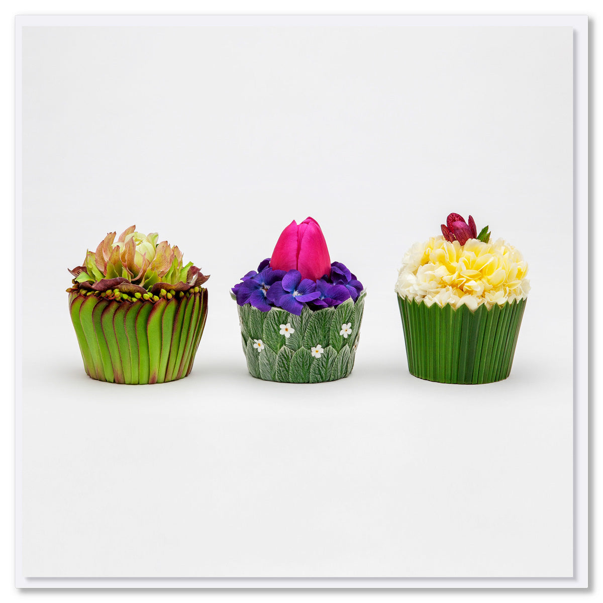 A delightful floral cupcakes greeting card. 3 individual cupcakes created from dainty flowers and soft leaves.  A quality square card found at Golly Gosh Creations.