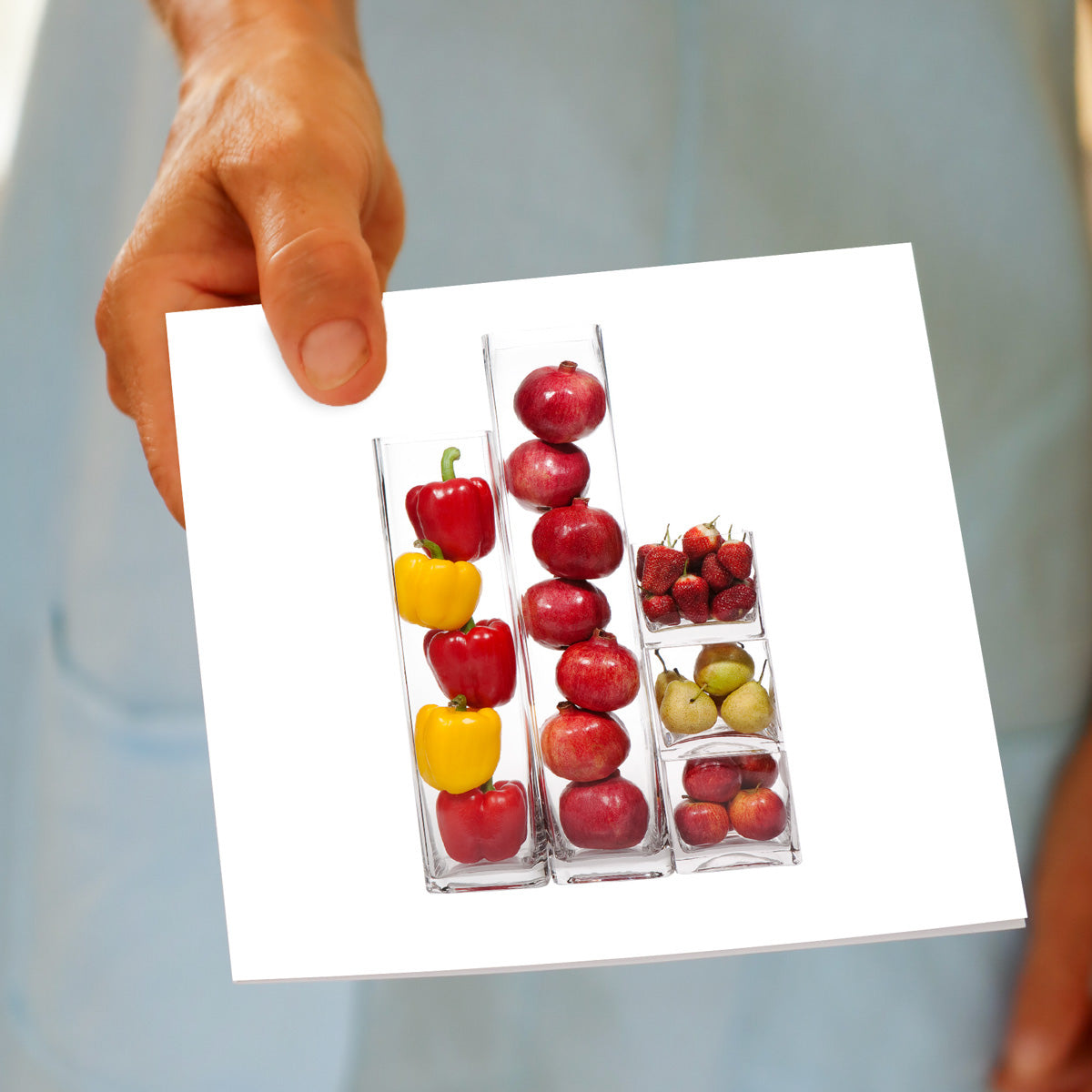 A fruit and veg vases greeting card being held by hand. A generous square card found at Golly Gosh Creations. 