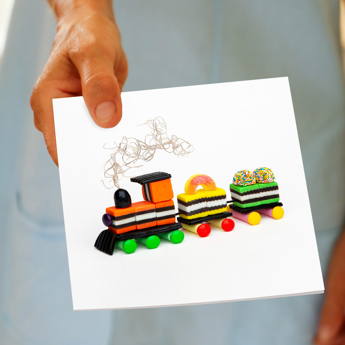 A hand held liquorice allsorts train greeting card from Golly Gosh Creations. A generous square card with a fun creation made from sweet confectionery.