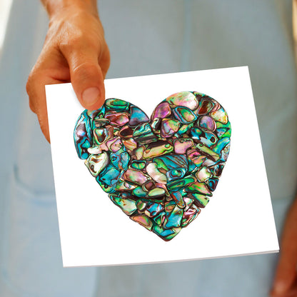 A hand held paua heart greeting card from Golly Gosh Creations. This generous square card is created using pieces of iridescent paua shells.