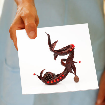 A hand held pod sandal greeting card from Golly Gosh Creations. This generous square card is crafted from brown autumn pods with a twist of red buds.