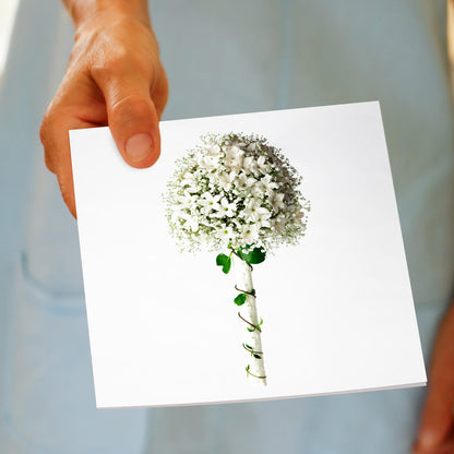 A stephanotis and gypsophila bouquet greeting card. being held by hand. A stunning arrangement on a white background. Size 142 x 142 mm