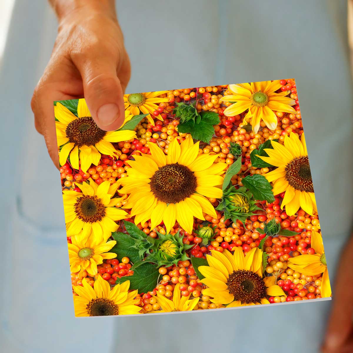 This sunflowers greeting card from Golly Gosh Creations is being hand held. A beautiful arrangement of bright sunflowers. Size 142 x 142 mm.