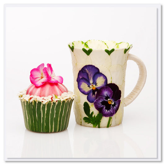 A tea break greeting card from Golly Gosh Creations. Size 142 x 142 mm. This sweet card has a pansy decorated mug and a cupcake created from flowers. 