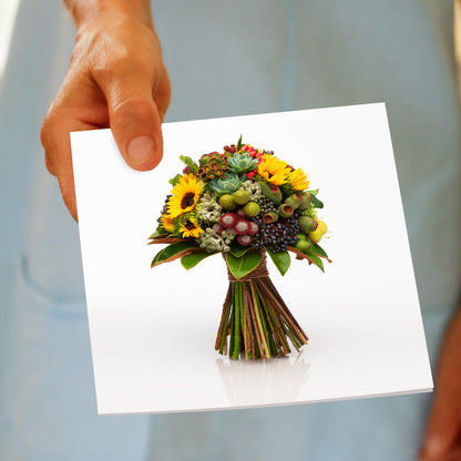 An elegant bouquet of sunflowers, berries and succulents on a white background being hand held. Size 142 x 142mm. A quality greeting card found at Golly Gosh Creations.